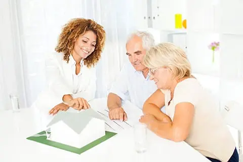 Older couple reviewing plans with Realtor.