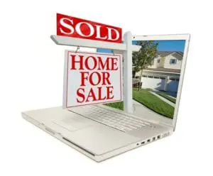 Sold Home for sale sign and laptop