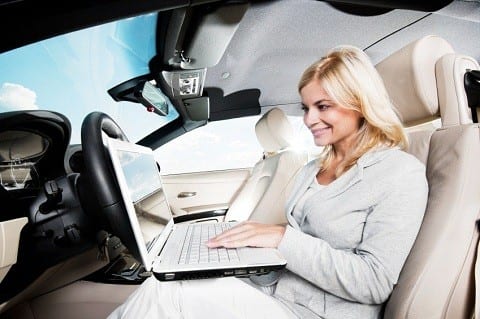 Side view of a smiling blonde woman sitting in her car and using a laptop. [url=http://www.istockphoto.com/search/lightbox/9786750][img]http://img291.imageshack.us/img291/2613/summerc.jpg[/img][/url]