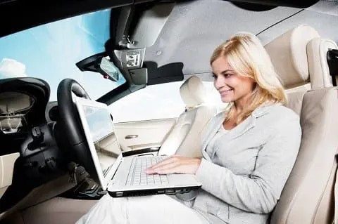 Side view of a smiling blonde woman sitting in her car and using a laptop. [url=http://www.istockphoto.com/search/lightbox/9786750][img]http://img291.imageshack.us/img291/2613/summerc.jpg[/img][/url]